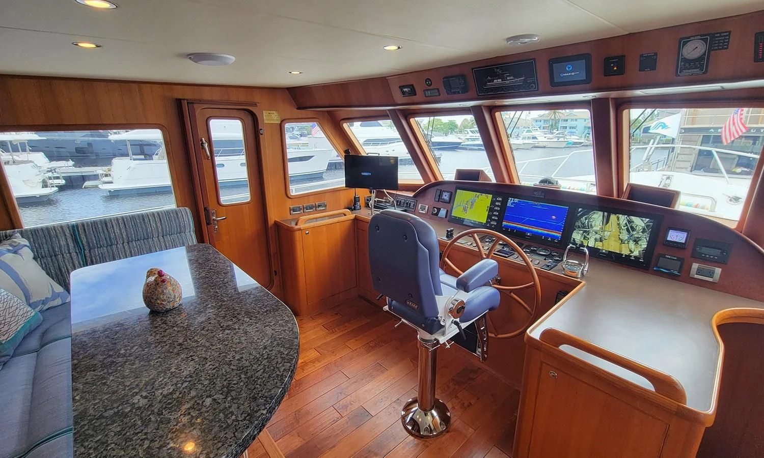 a room with a table and chairs aboard SUERTUDO Yacht for Sale