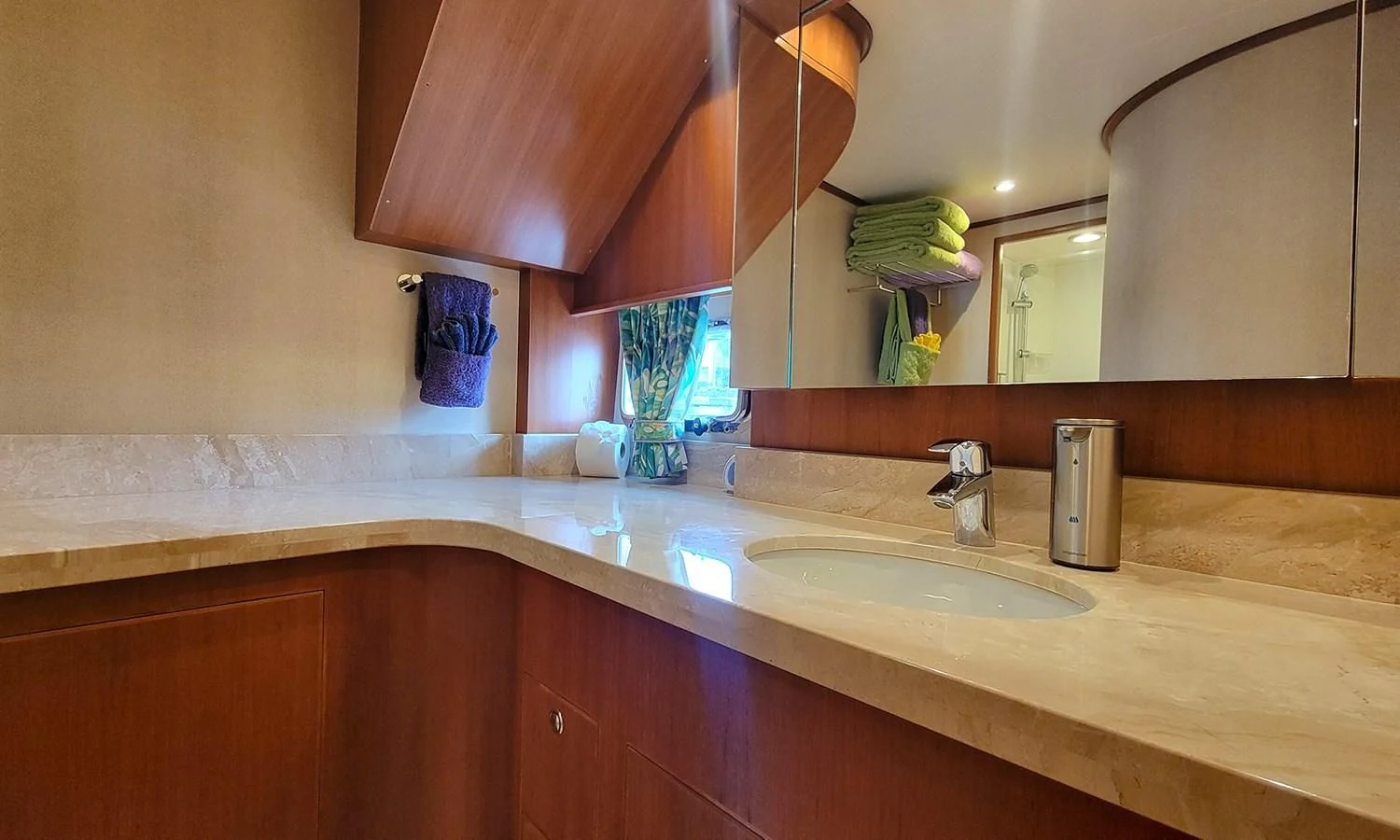a bathroom with a countertop sink and a mirror aboard SUERTUDO Yacht for Sale