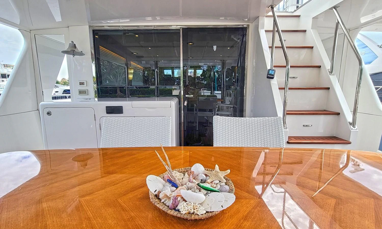 a plate of sushi on a table in a room with a large window aboard SUERTUDO Yacht for Sale