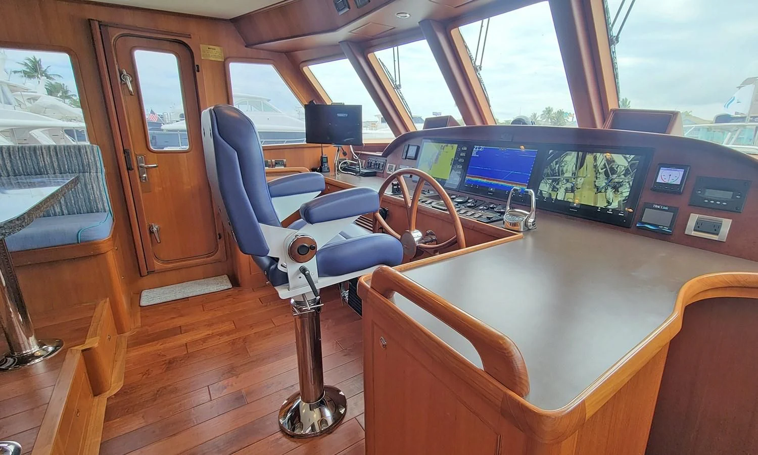 inside of a vehicle with a table and chairs and a computer on a stand aboard SUERTUDO Yacht for Sale