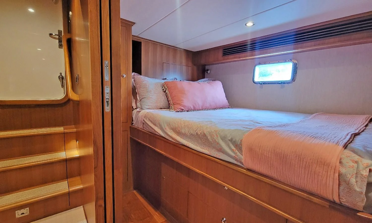 a room with a bed and a closet aboard SUERTUDO Yacht for Sale