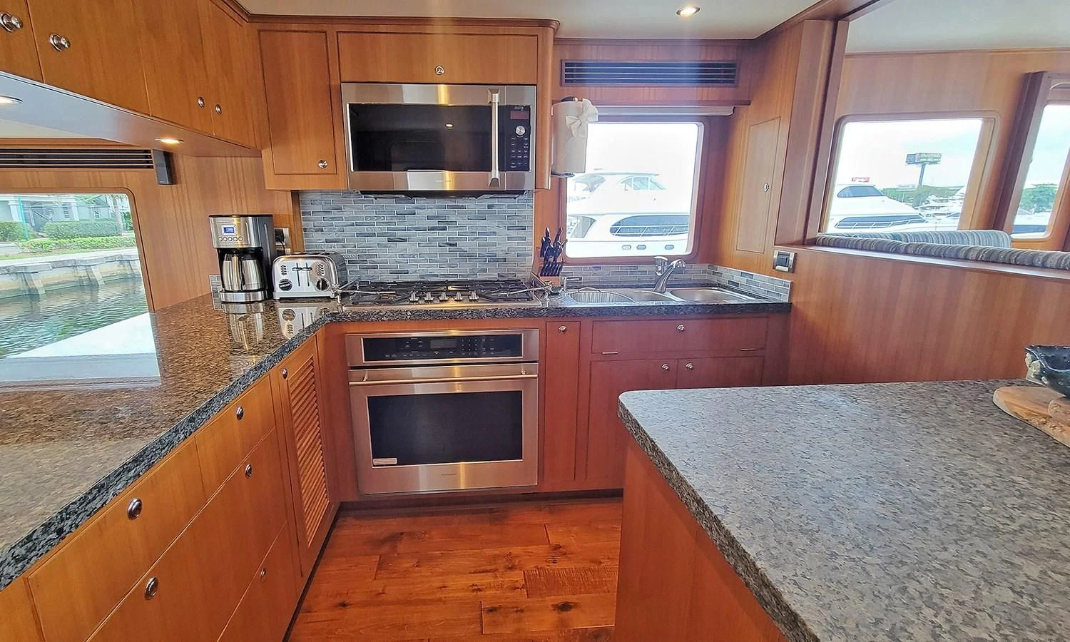 a kitchen with wooden cabinets aboard SUERTUDO Yacht for Sale