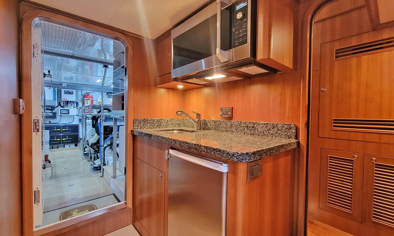 a kitchen with a sink and microwave aboard SUERTUDO Yacht for Sale