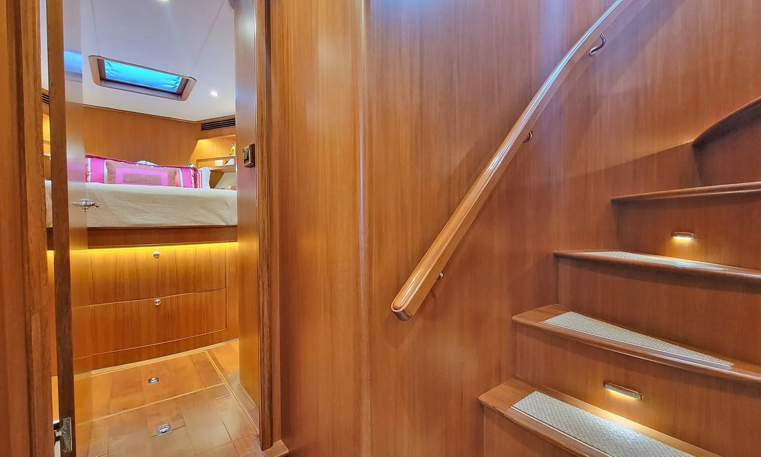 a wooden staircase with a wood railing aboard SUERTUDO Yacht for Sale