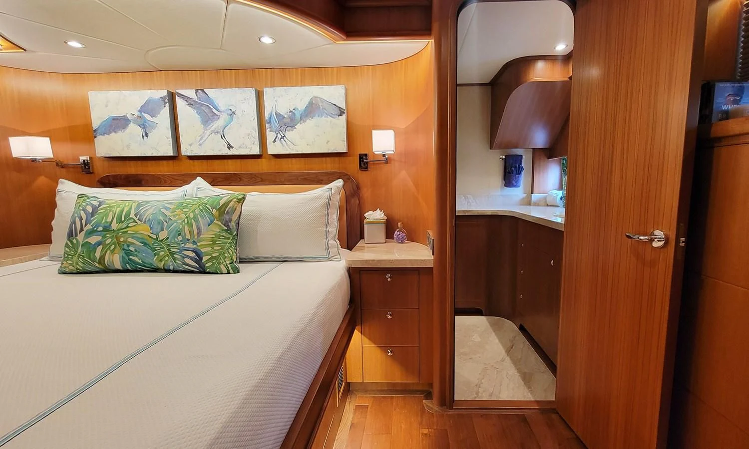 a bedroom with a bed and a mirror aboard SUERTUDO Yacht for Sale