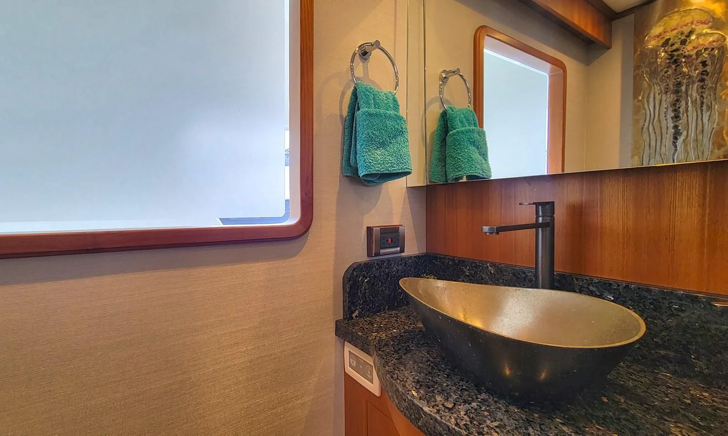 a bathroom with a sink and towels aboard SUERTUDO Yacht for Sale