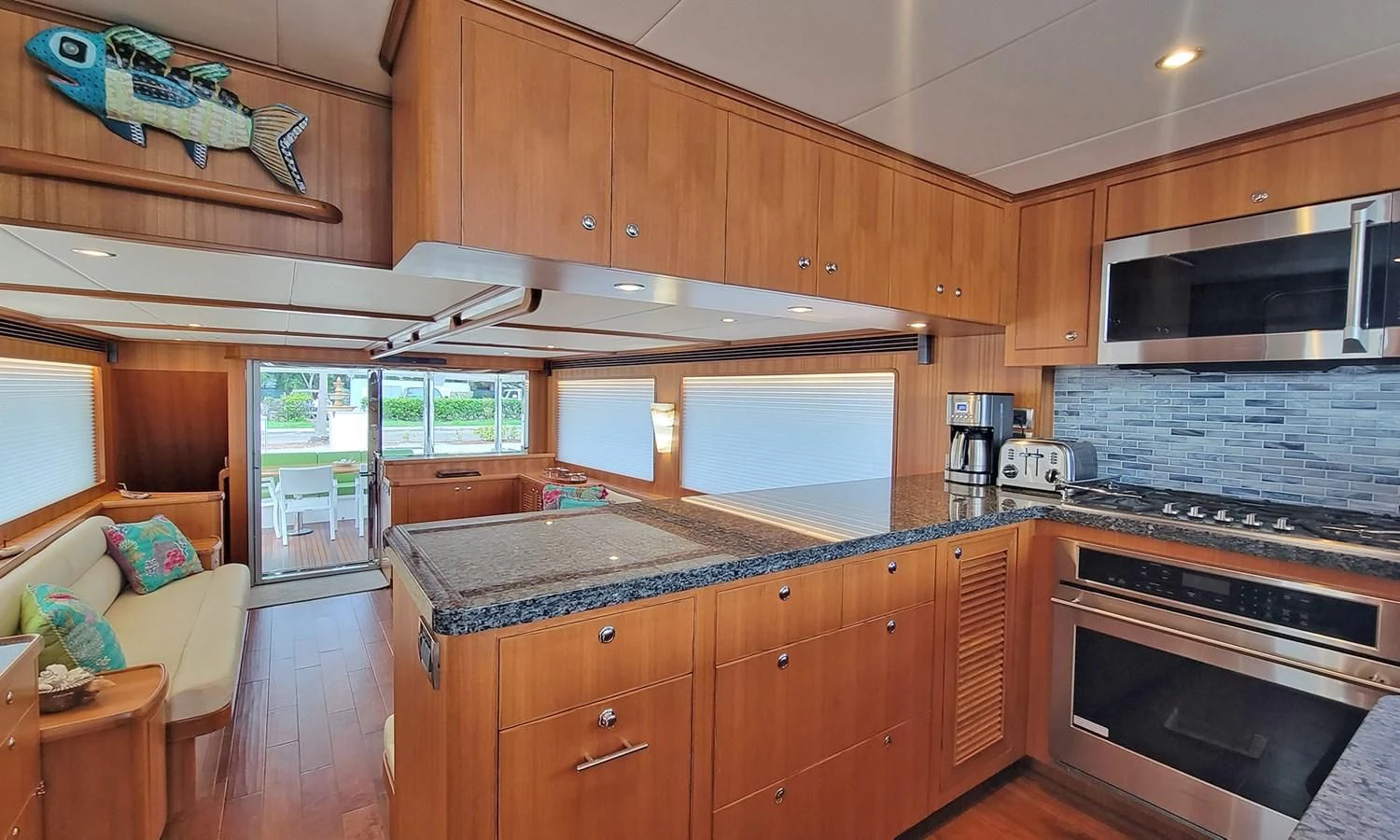 a kitchen with wooden cabinets aboard SUERTUDO Yacht for Sale