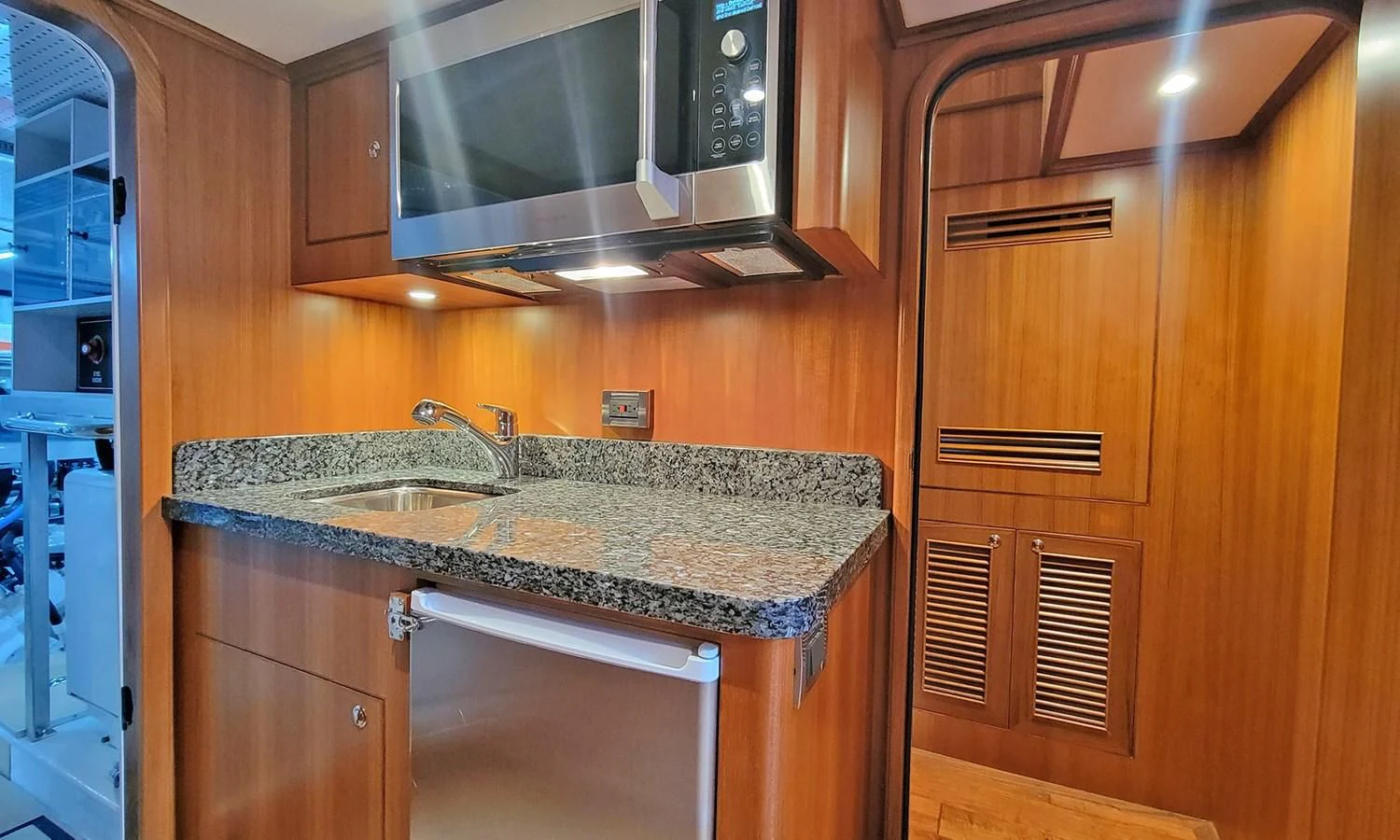 a kitchen with wooden cabinets aboard SUERTUDO Yacht for Sale