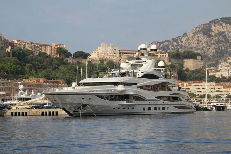 a large white boat in a harbor aboard LIONHEART Yacht for Sale