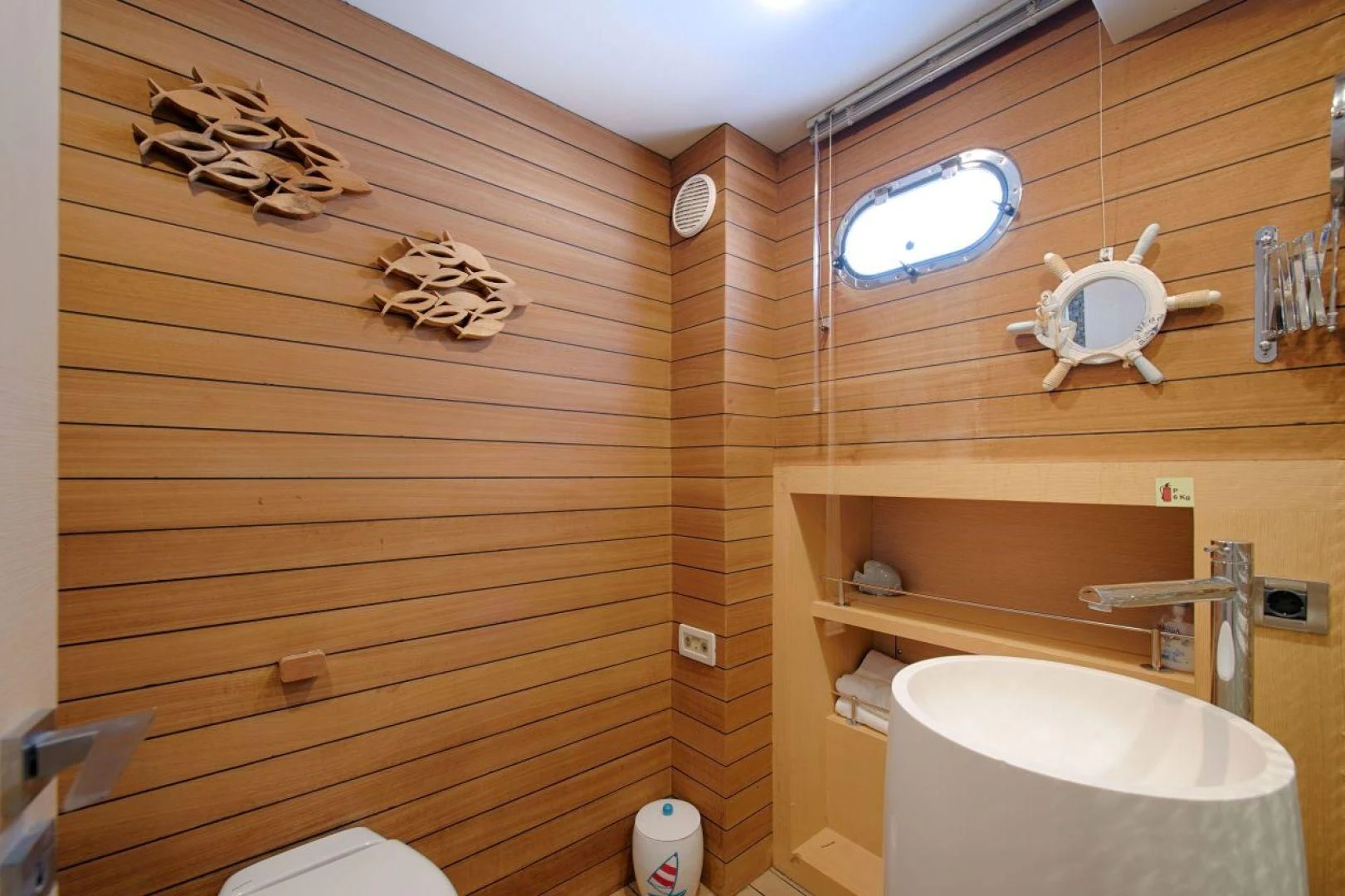 a bathroom with wood walls aboard THE WALL Yacht for Sale