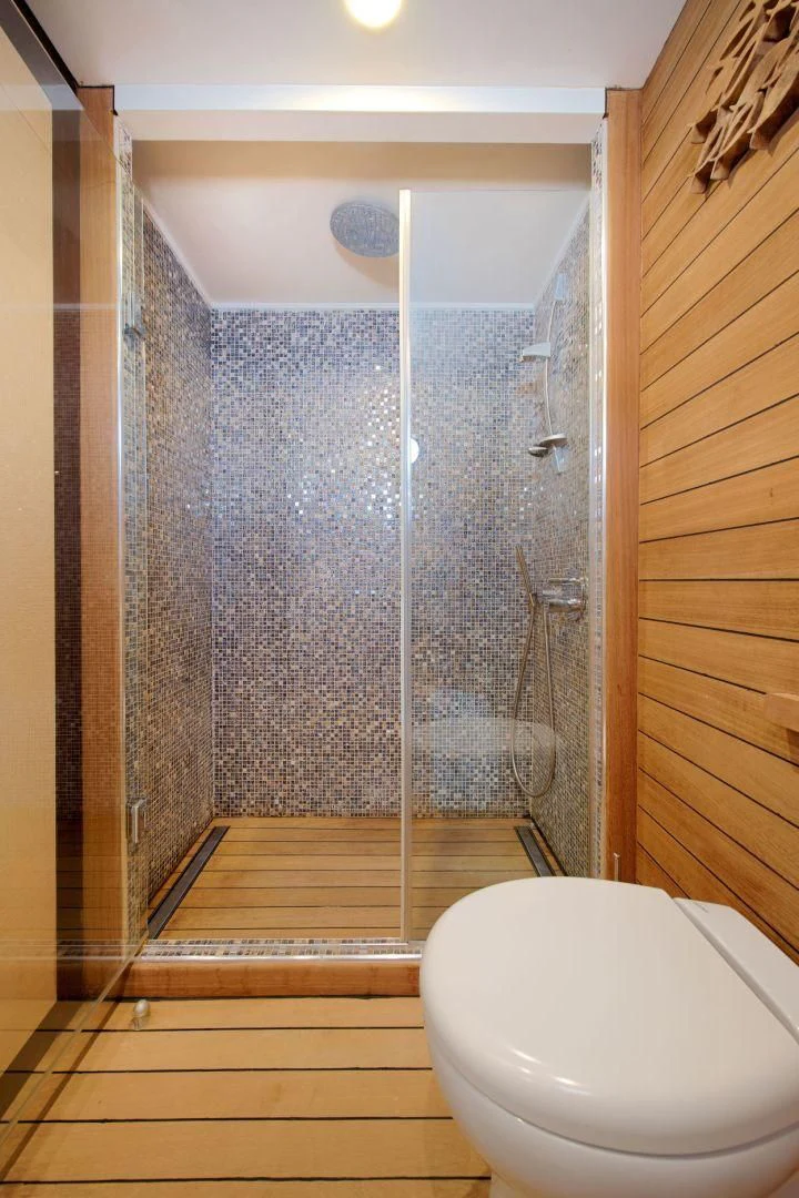 a bathroom with a glass shower aboard THE WALL Yacht for Sale