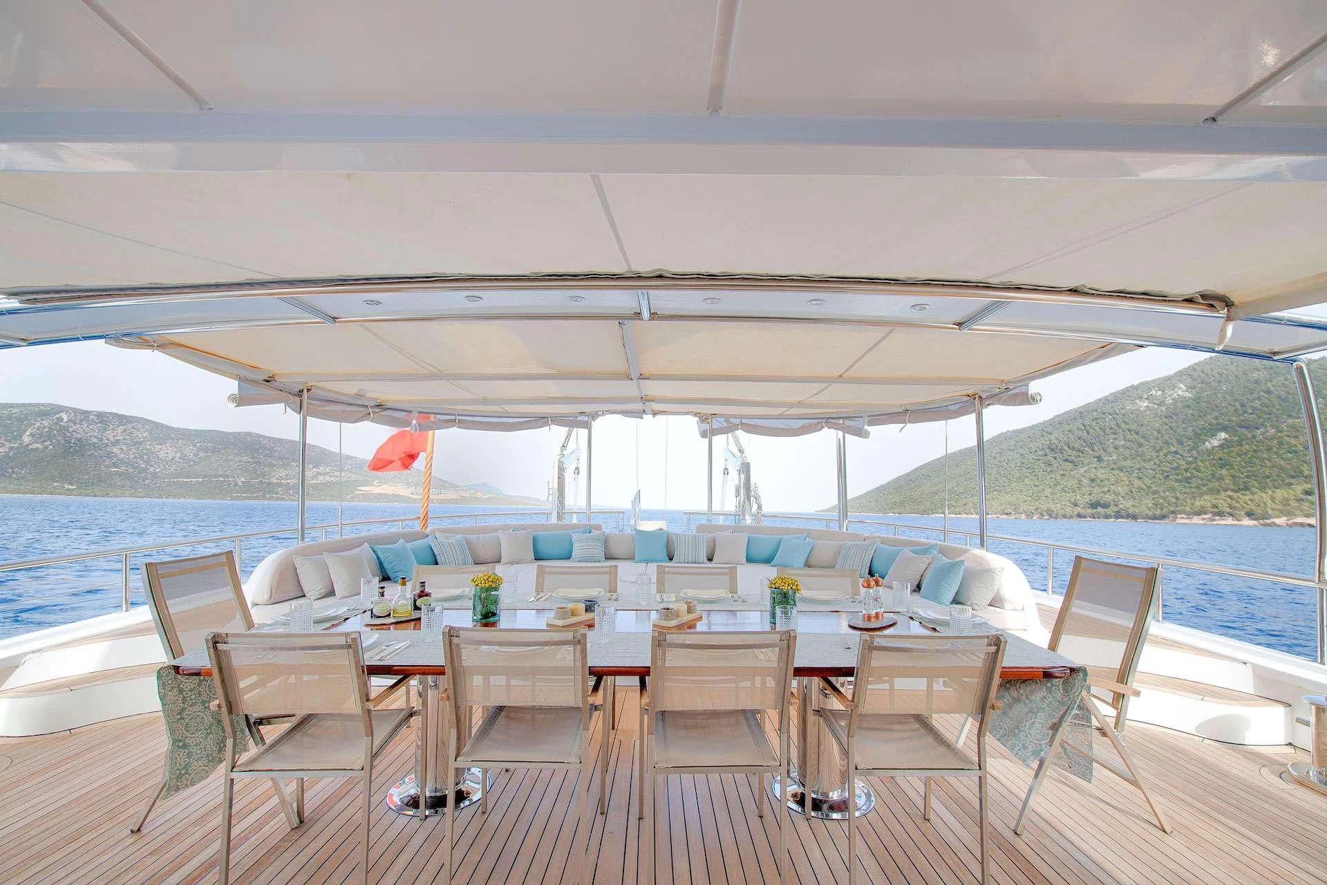 a large white tent with chairs and tables and a pool aboard THE WALL Yacht for Sale