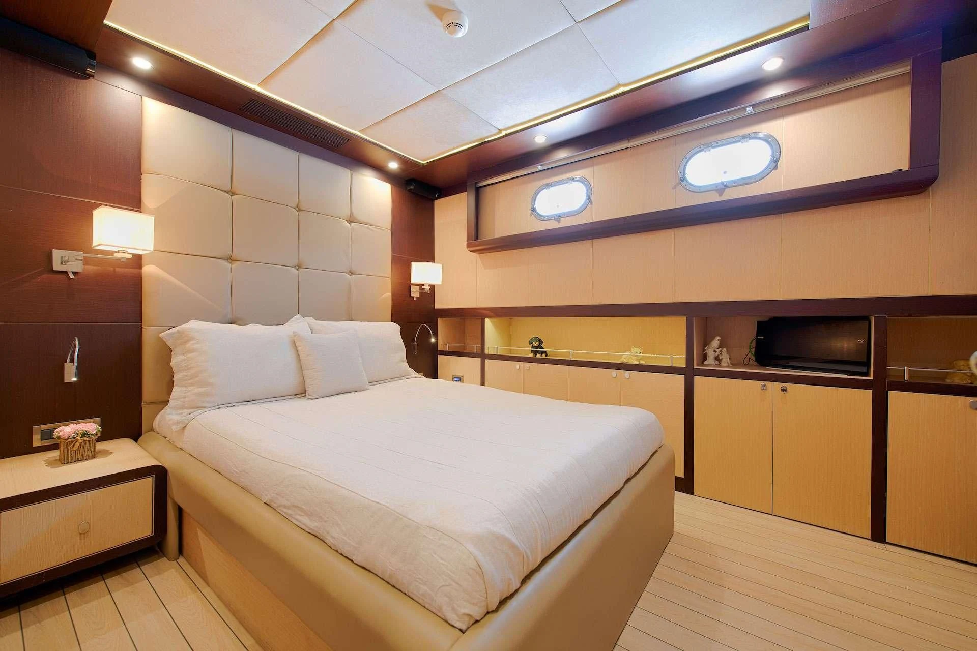a room with a bed and a television aboard THE WALL Yacht for Sale