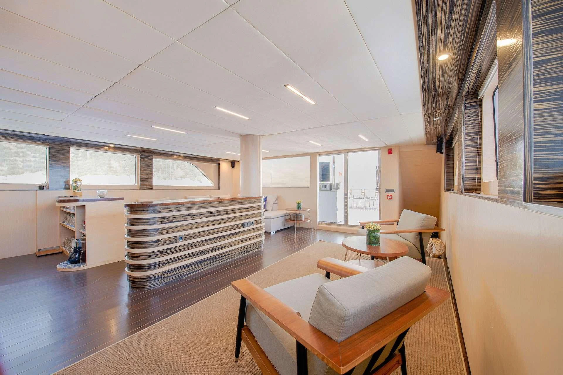 a room with a table and chairs aboard THE WALL Yacht for Sale
