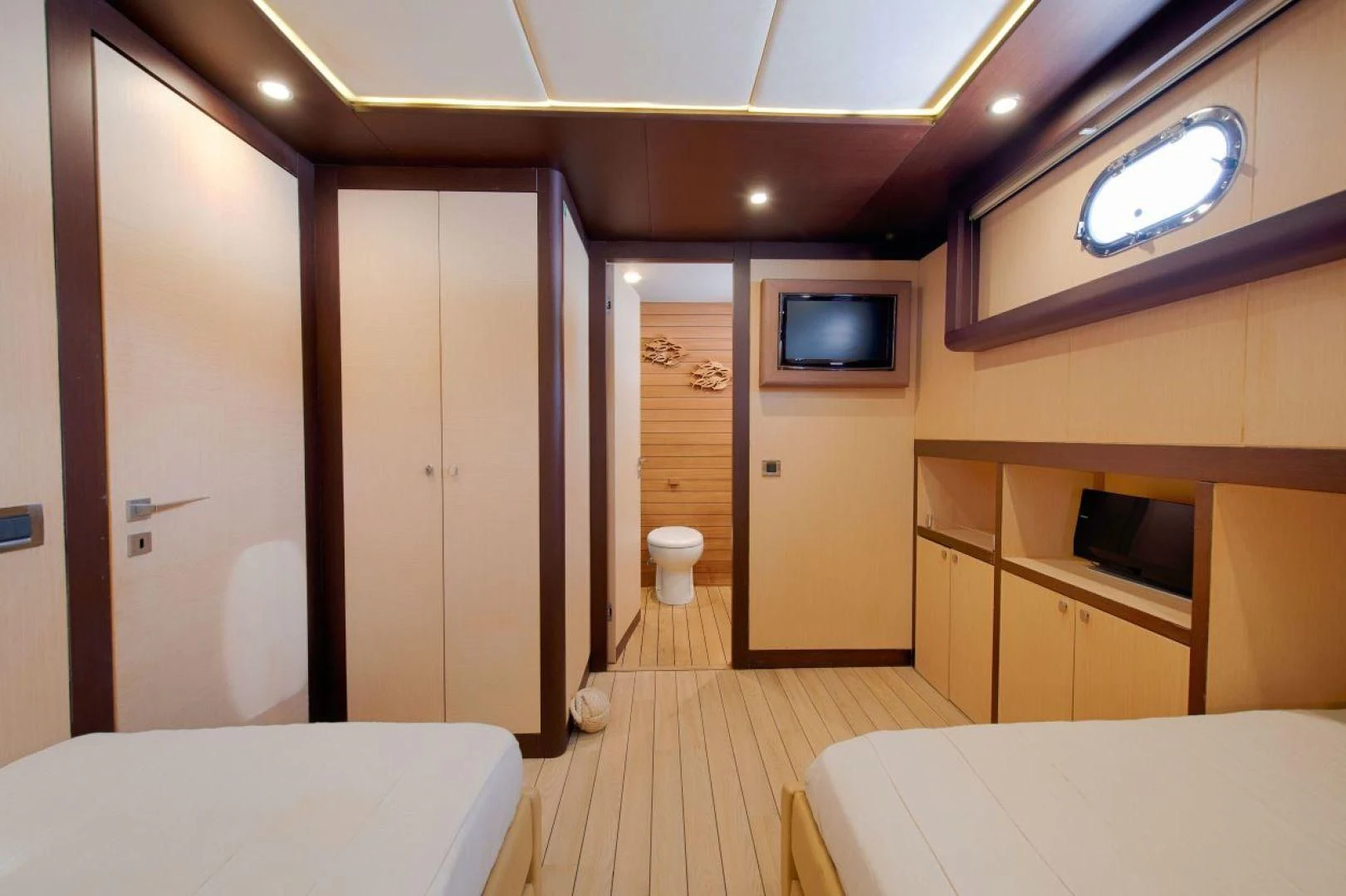 a room with a bed and a tv on the wall aboard THE WALL Yacht for Sale