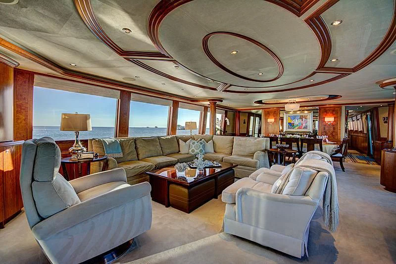 a living room with a large chandelier aboard LADY GRAY Yacht for Sale