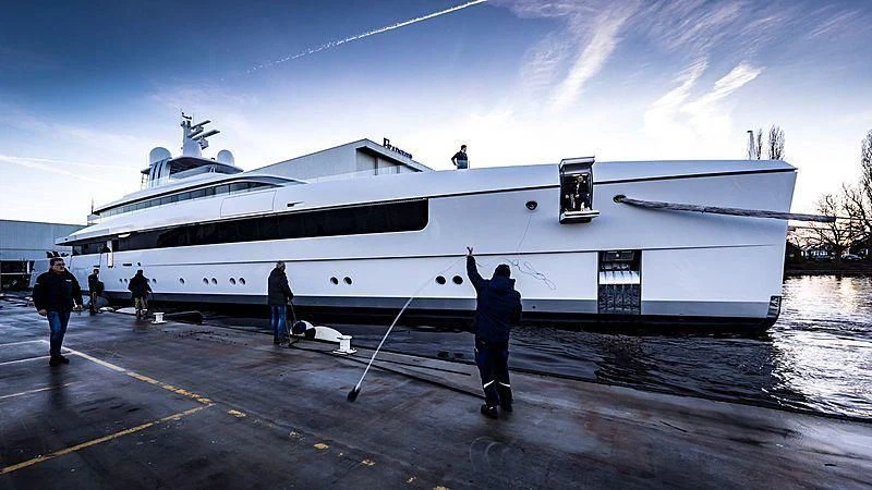 a large white boat with a group of people standing in front of it aboard JC Yacht for Sale