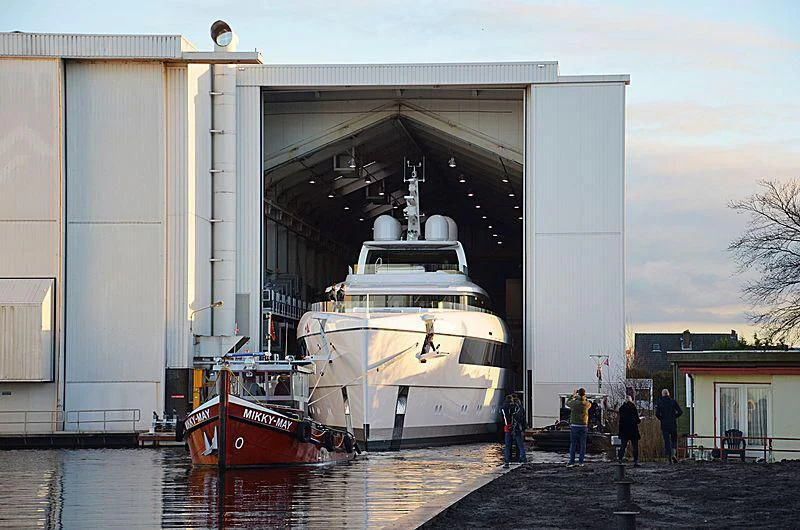 a large white boat sits in a dock aboard JC Yacht for Sale