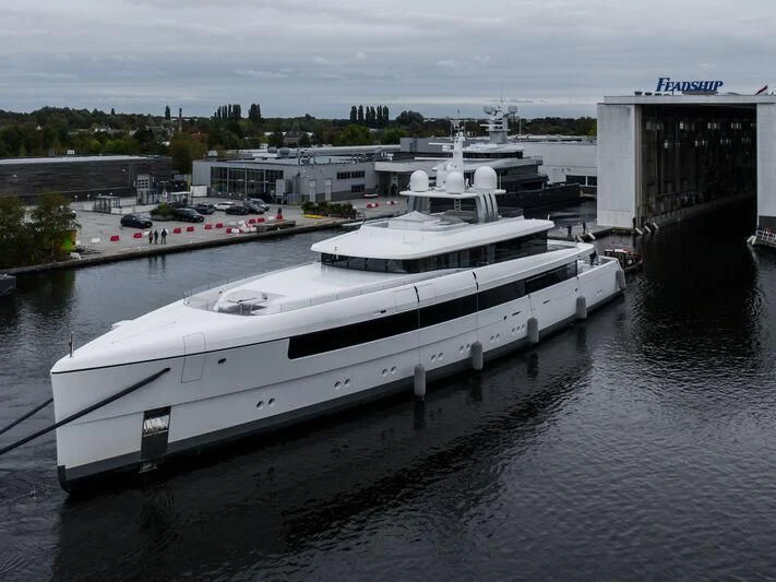 a white yacht docked at a dock aboard JC Yacht for Sale