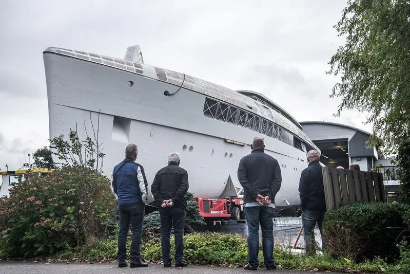 a group of people standing outside a building aboard JC Yacht for Sale