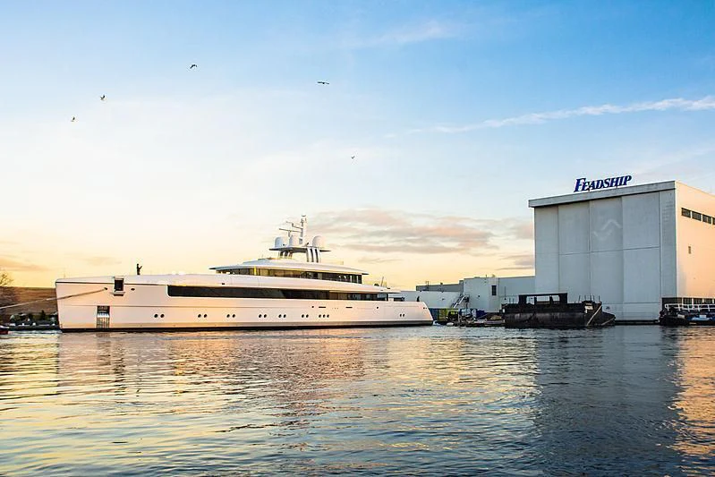 a large white boat in a harbor aboard JC Yacht for Sale