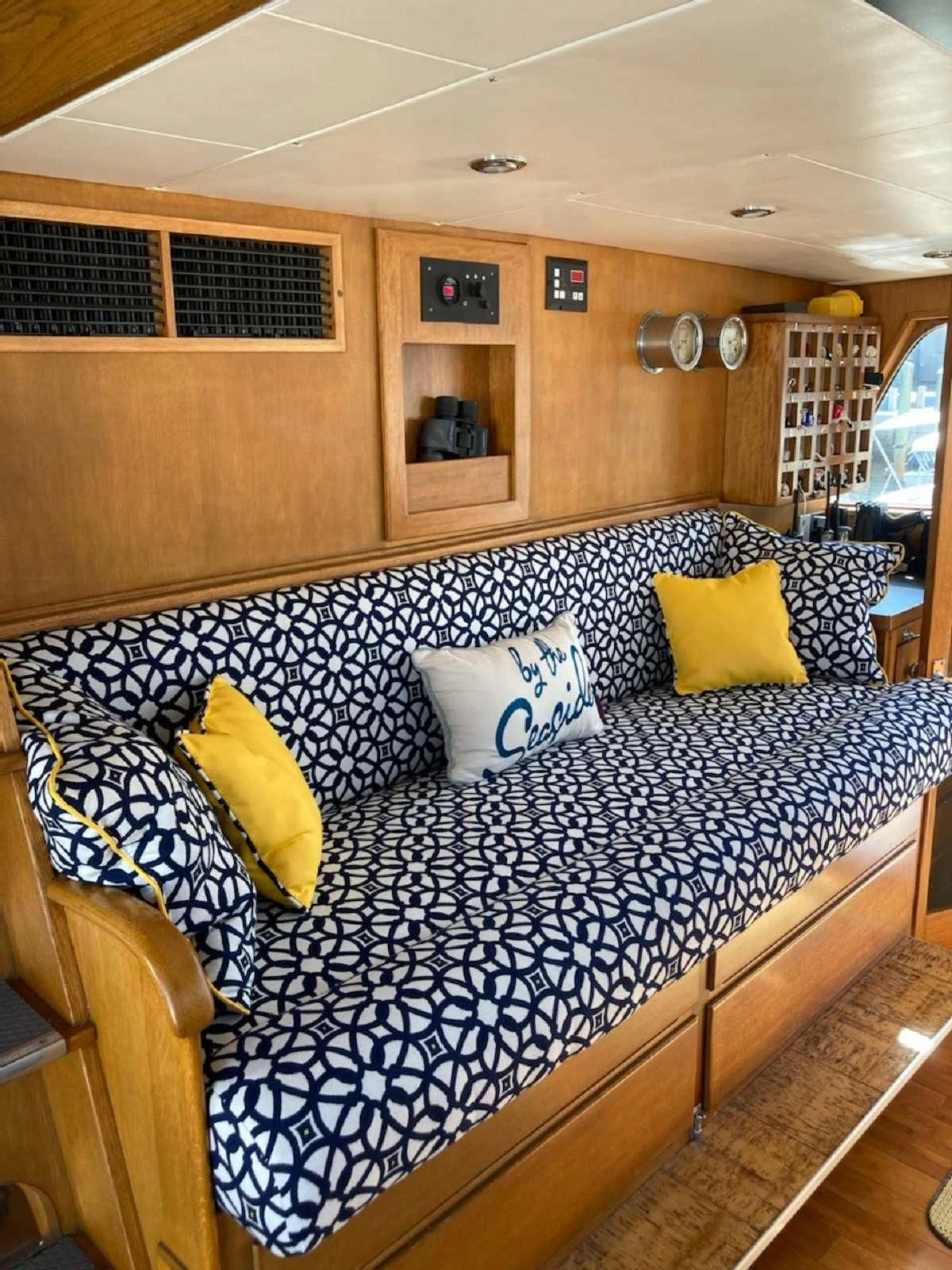 a bed with blue and yellow pillows aboard KOALA Yacht for Sale