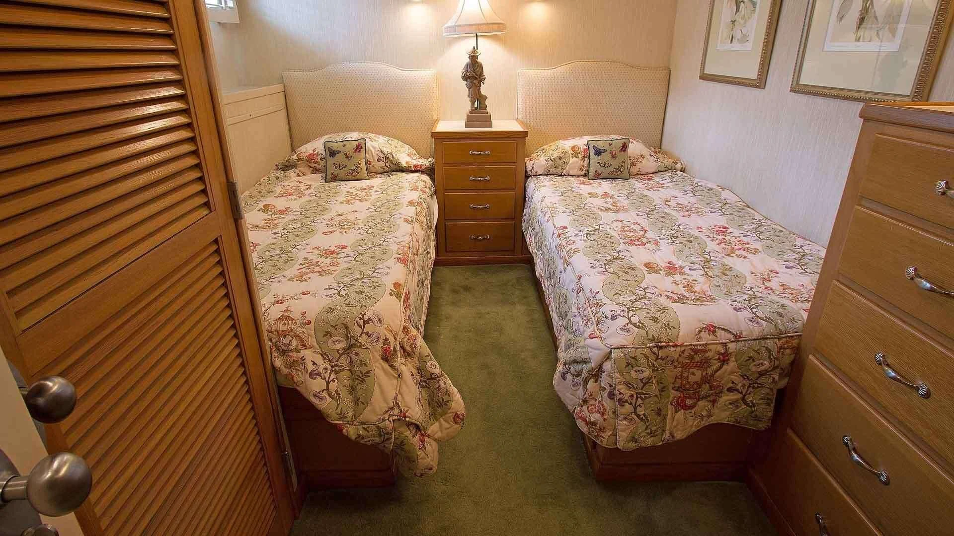 a bedroom with two beds aboard KOALA Yacht for Sale