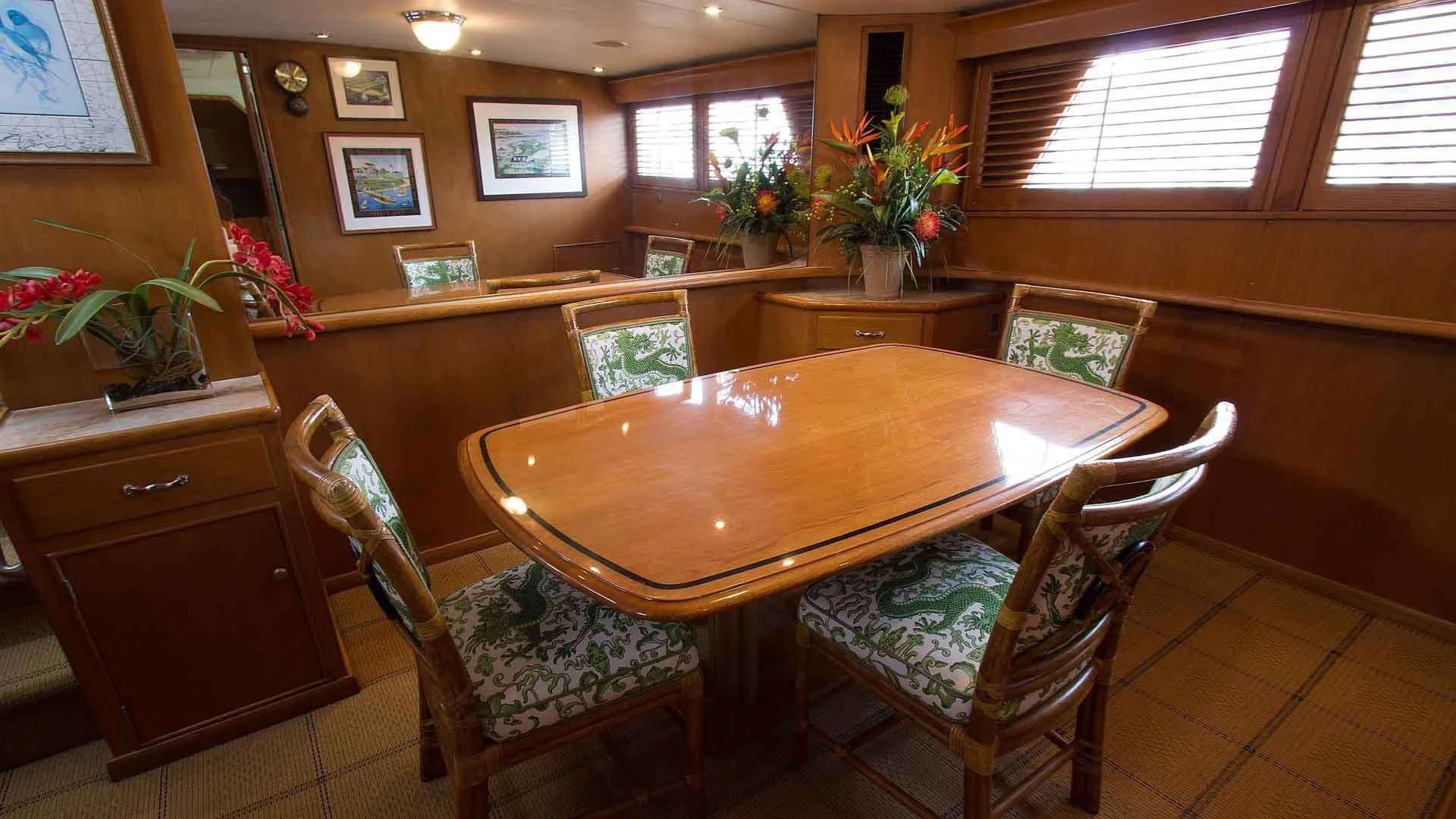 a dining table in a room aboard KOALA Yacht for Sale
