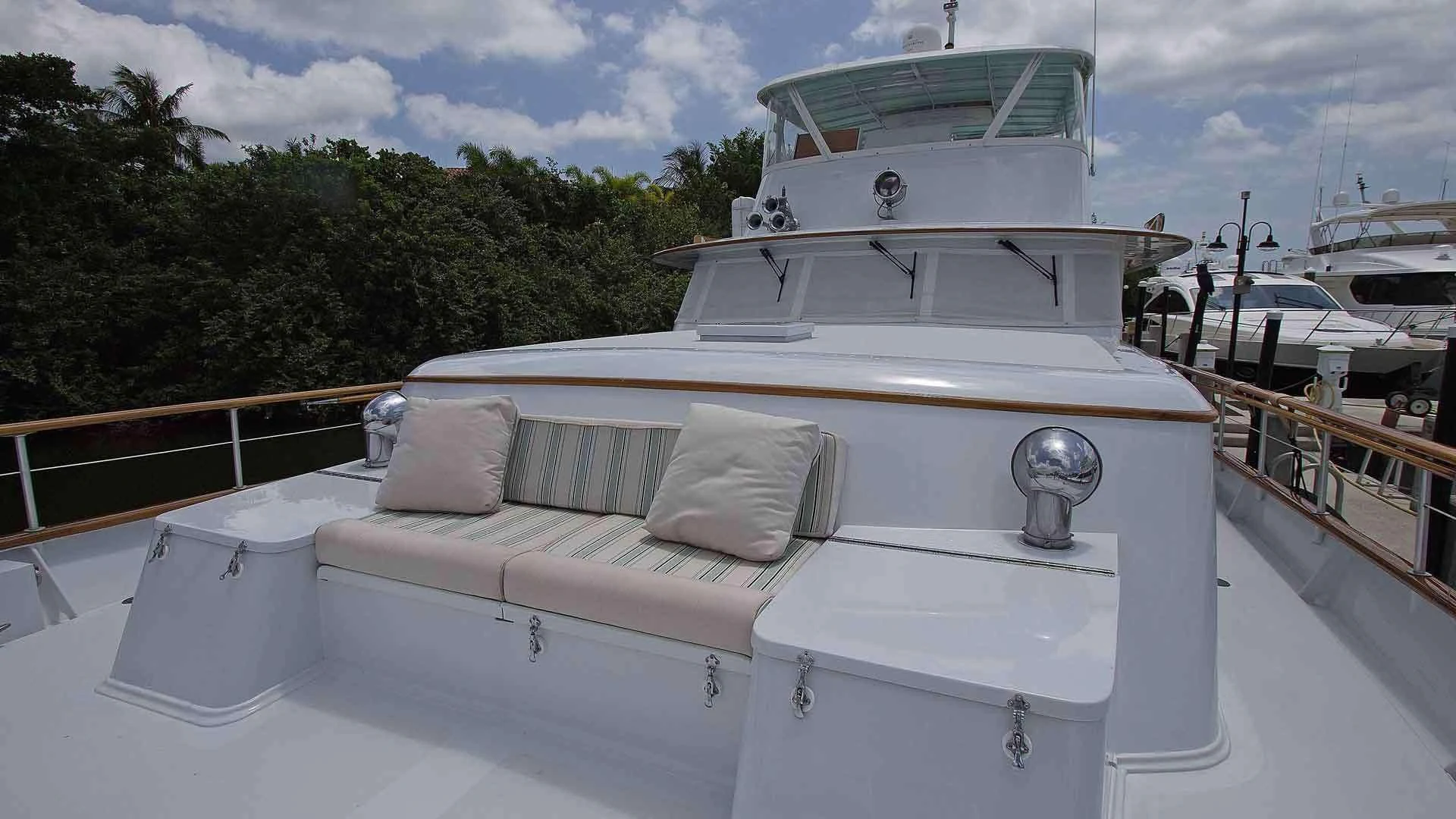 a white boat with pillows on a deck aboard KOALA Yacht for Sale