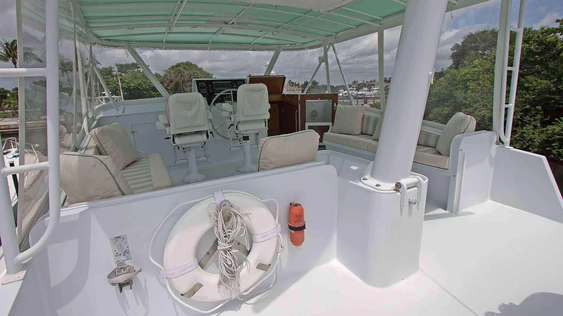 a white bathtub with a sink and chairs in a room with a window and a view of aboard KOALA Yacht for Sale