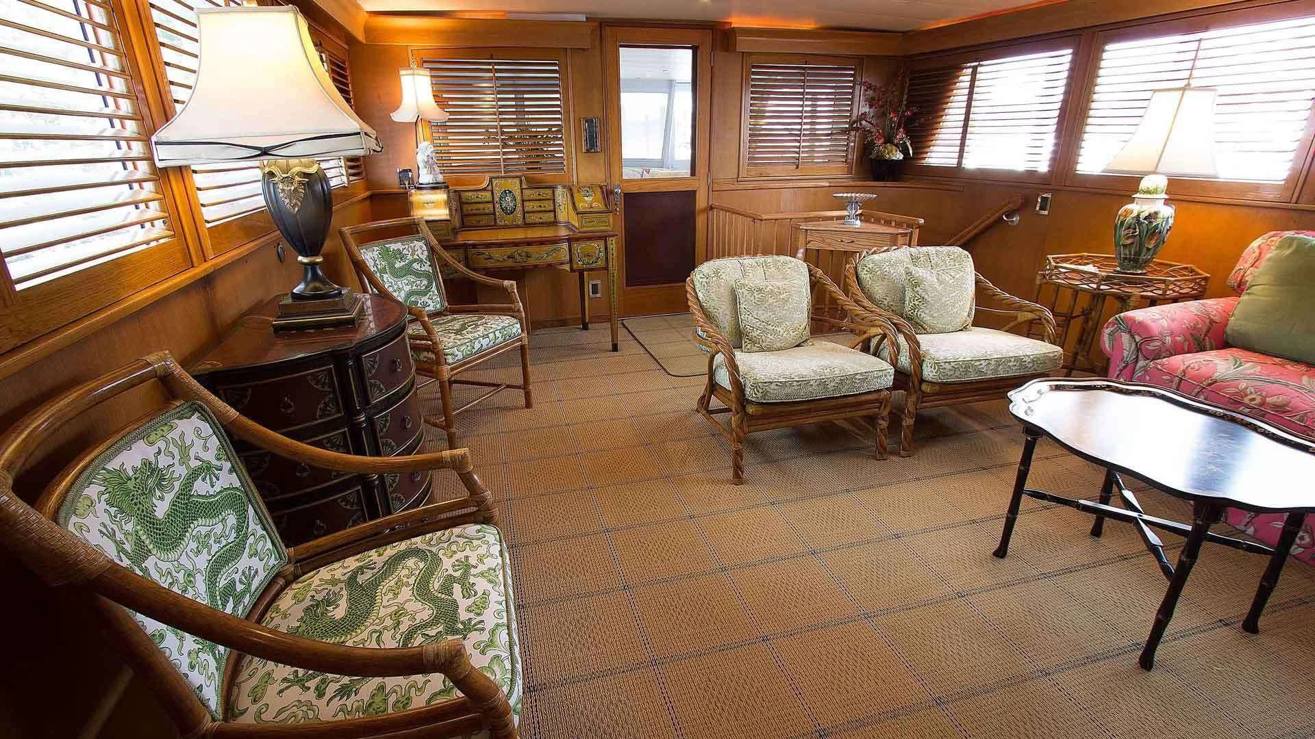 a living room with a table and chairs aboard KOALA Yacht for Sale