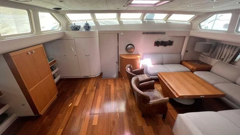 a living room with a wood floor aboard BLUE FASCINATION Yacht for Sale