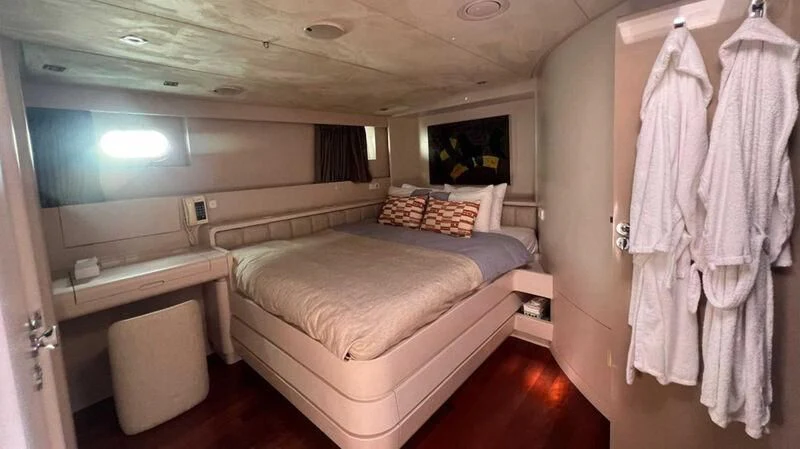 a room with a bed and a desk aboard BLUE FASCINATION Yacht for Sale