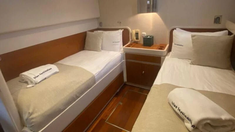 a couple of beds in a hotel room aboard BLUE FASCINATION Yacht for Sale