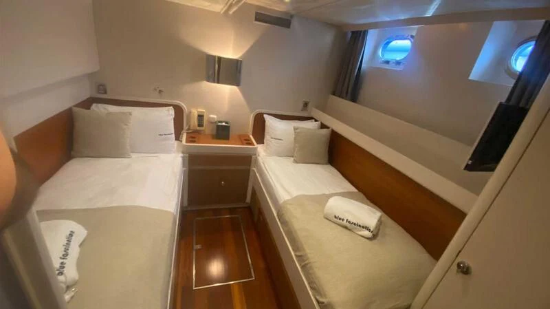 a room with two beds aboard BLUE FASCINATION Yacht for Sale