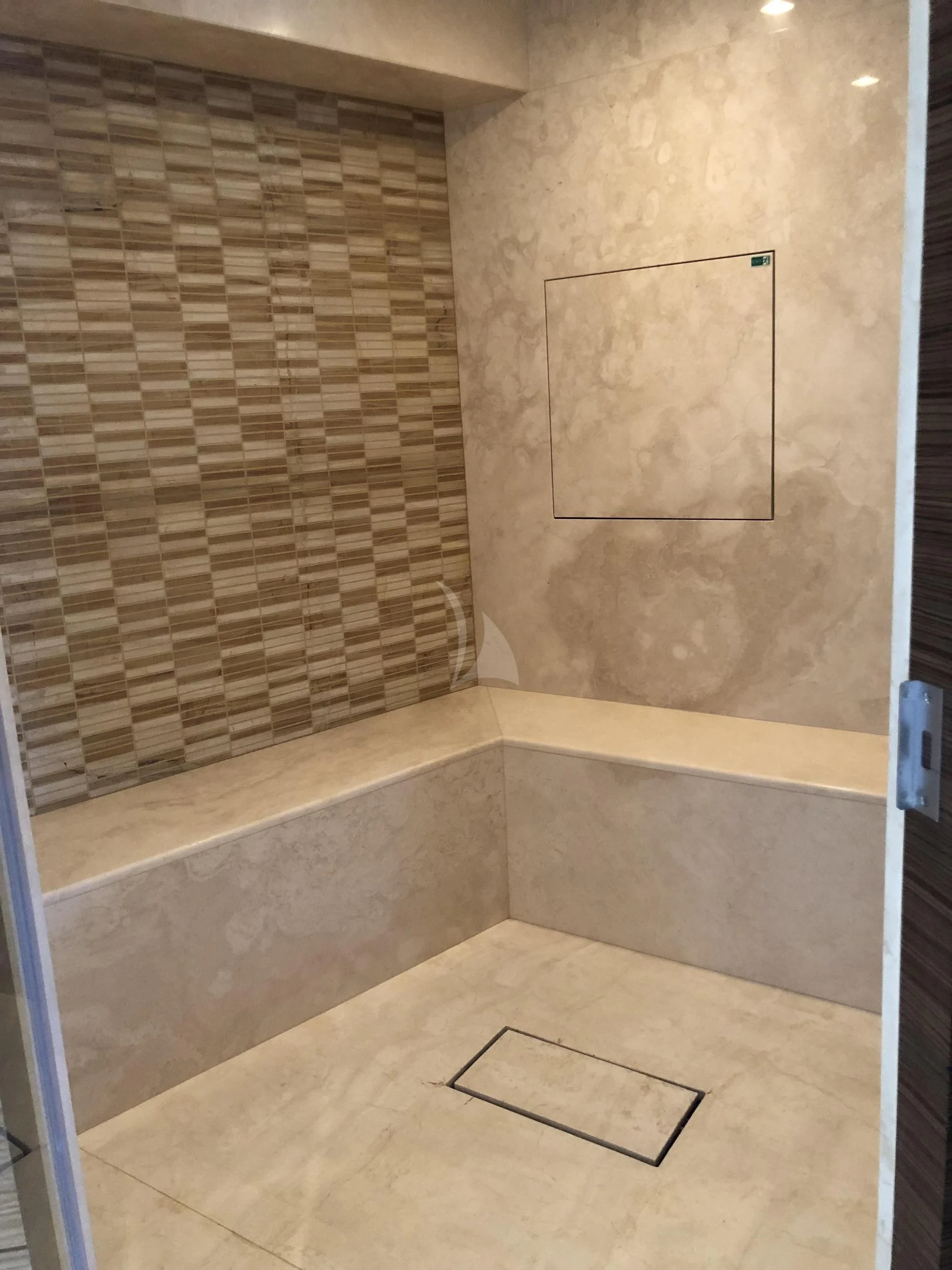 a tiled bathroom with a glass shower aboard ORYX Yacht for Sale