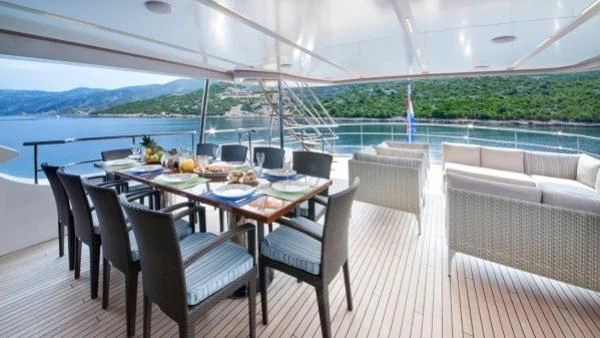 a table and chairs on a deck aboard ORYX Yacht for Sale