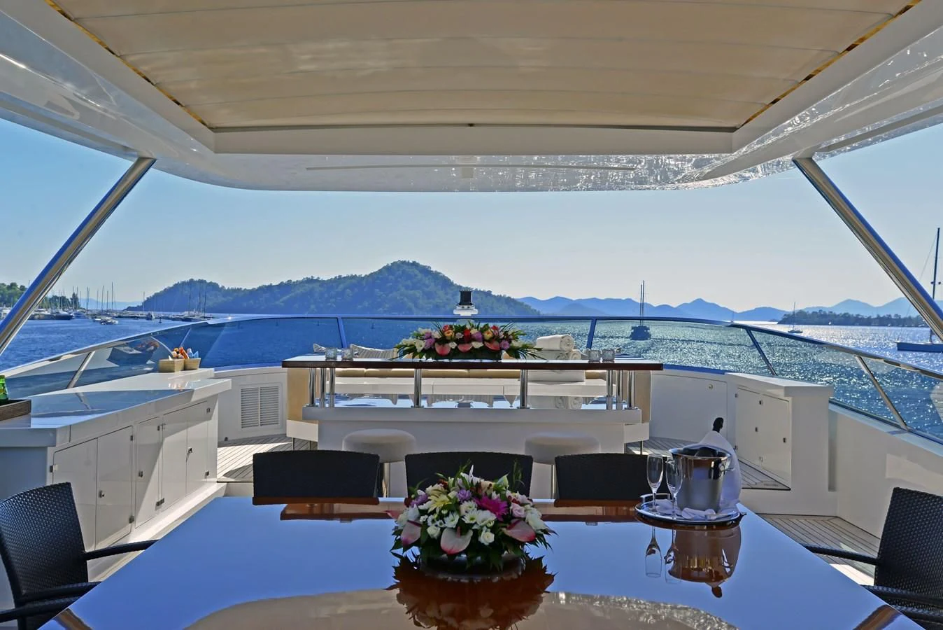 a large white table with flowers on it aboard ORYX Yacht for Sale