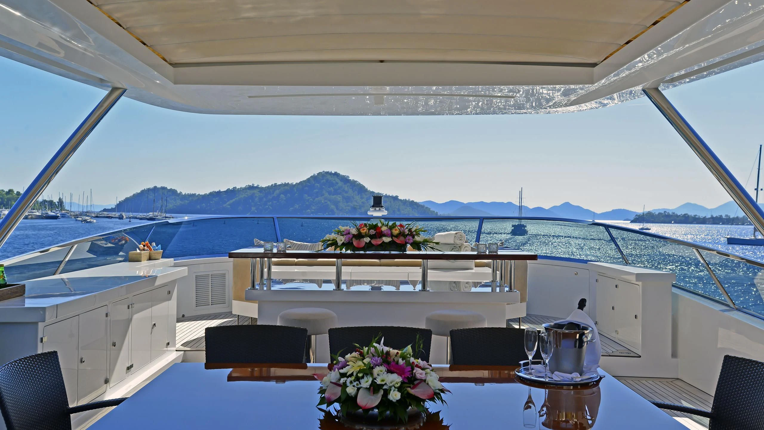a table with flowers on it aboard ORYX Yacht for Sale