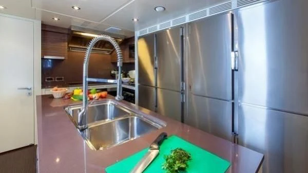 a kitchen with stainless steel appliances aboard ORYX Yacht for Sale