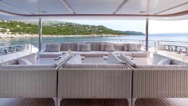 a couch and a table on a boat aboard ORYX Yacht for Sale