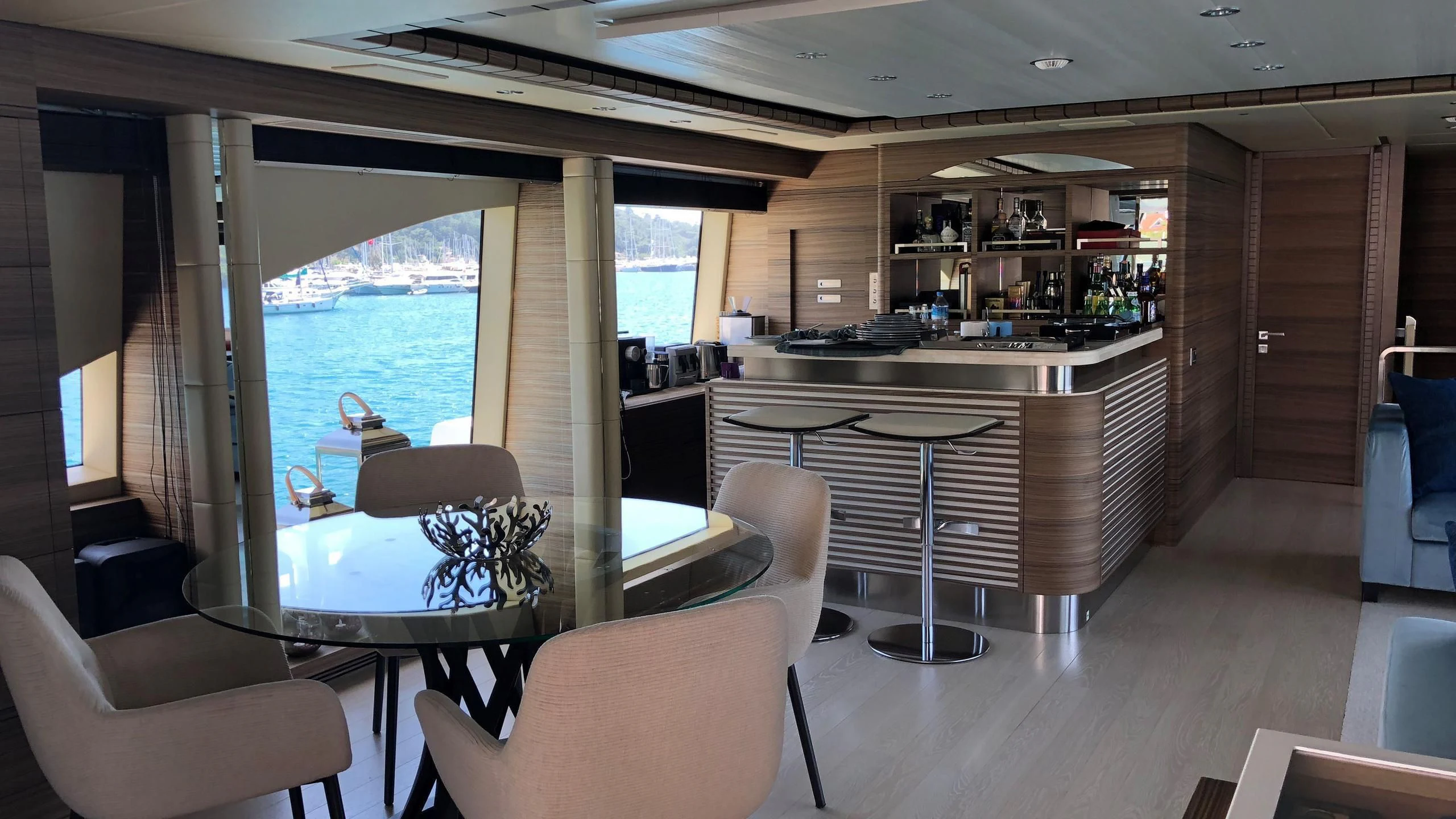 a room with a table chairs and a window aboard ORYX Yacht for Sale