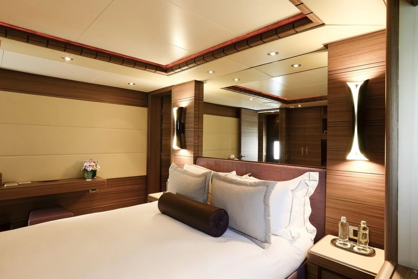 a bed with a white bed spread aboard ORYX Yacht for Sale