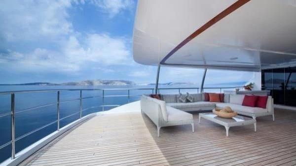 a room with a couch and a table and a large body of water aboard ORYX Yacht for Sale