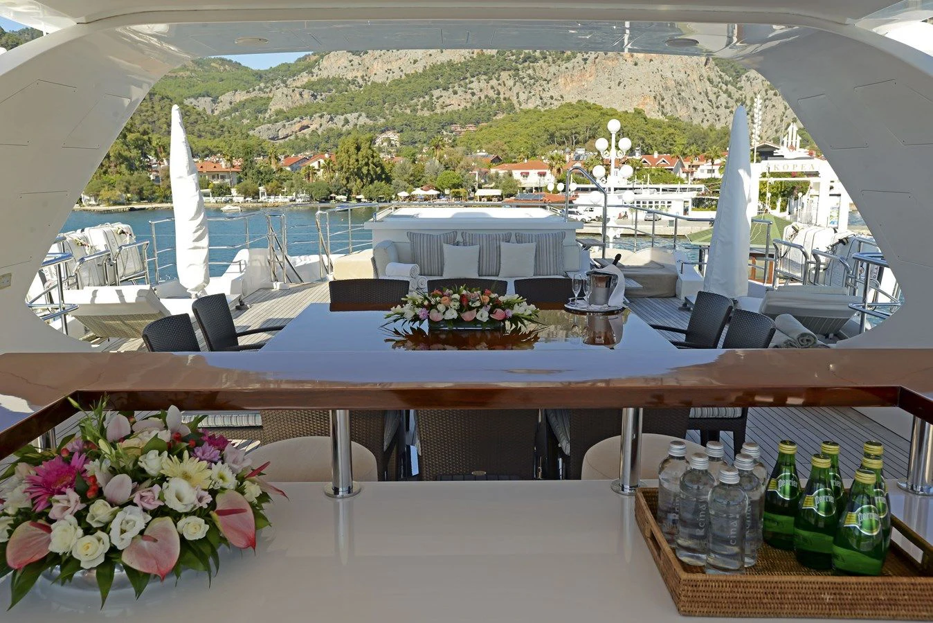 a table with wine bottles and glasses on it aboard ORYX Yacht for Sale
