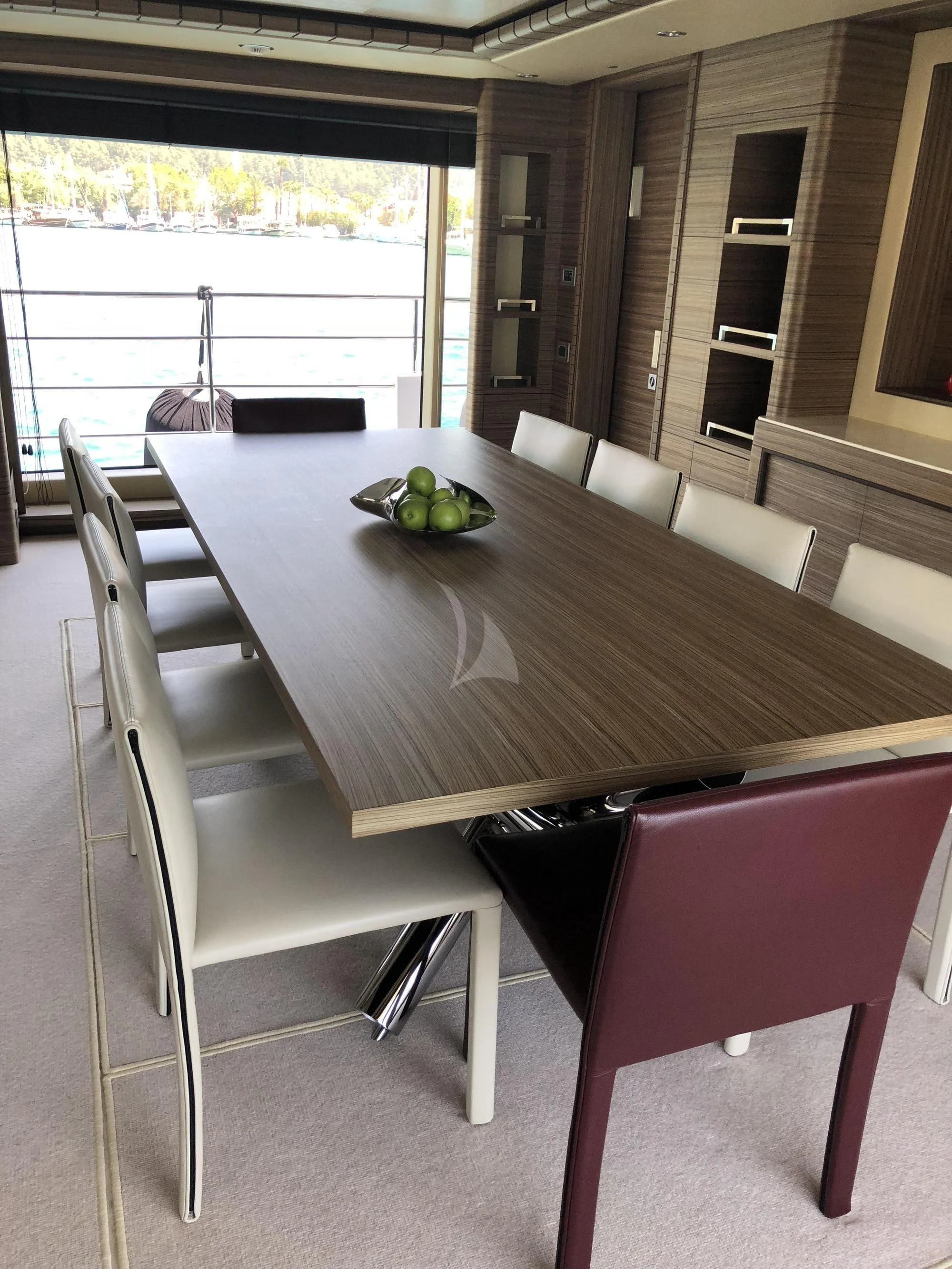 a table with chairs and a couch aboard ORYX Yacht for Sale
