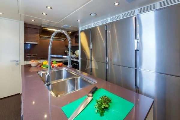 a kitchen with stainless steel appliances aboard ORYX Yacht for Sale