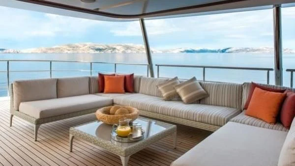 a couch with pillows and pillows aboard ORYX Yacht for Sale