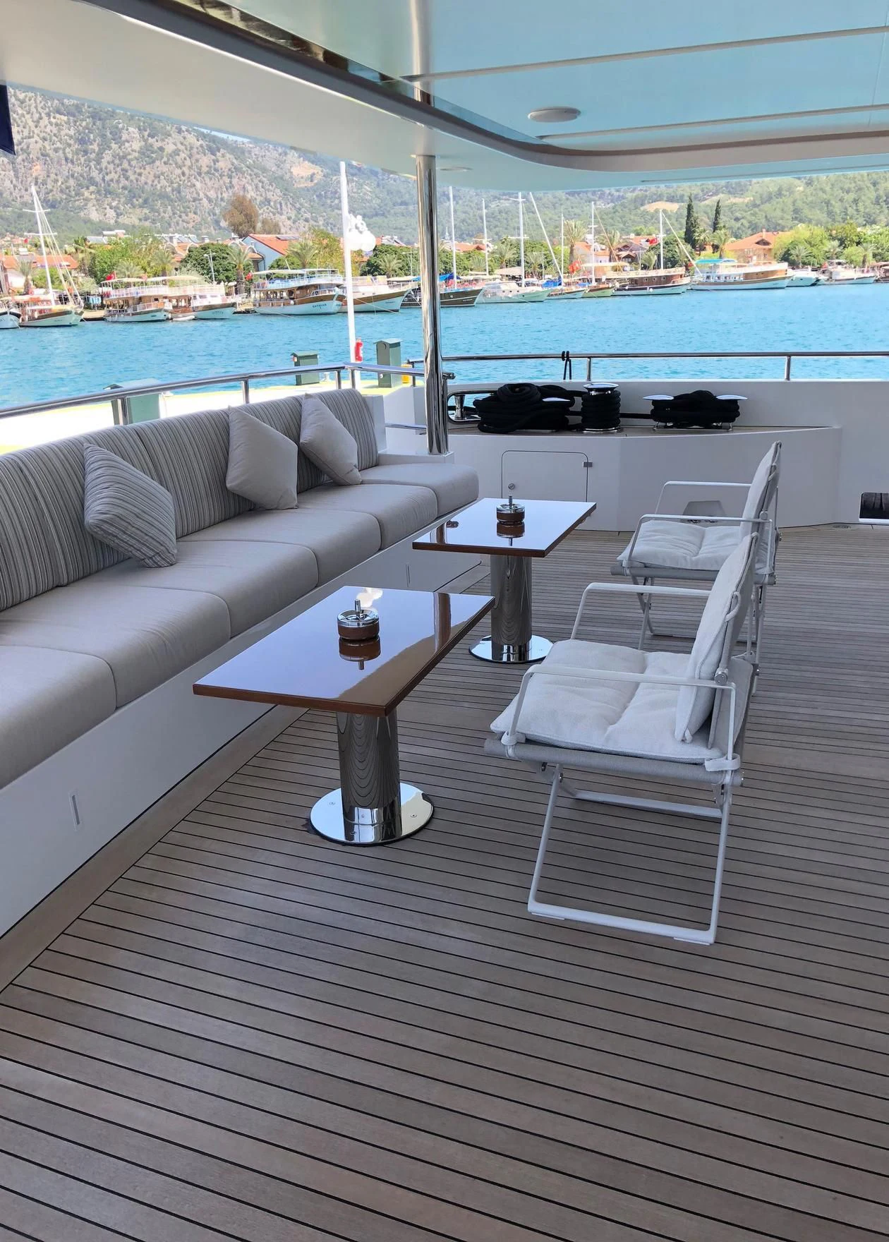 a room with a couch and a table and a view of the water aboard ORYX Yacht for Sale