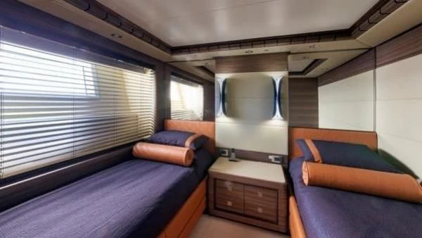 a room with a bed and a mirror aboard ORYX Yacht for Sale